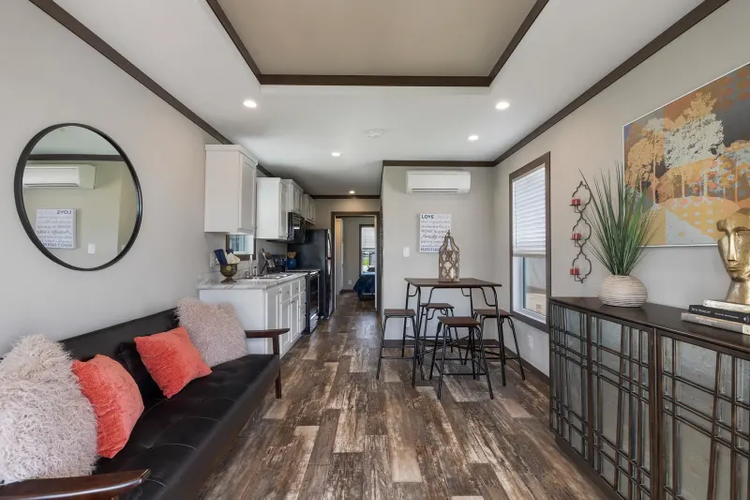 A tiny home with stairs coming up both sides to the door.