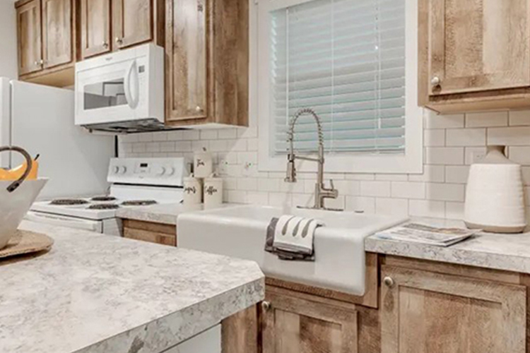 Wood cabinets and sink in a kitchen.